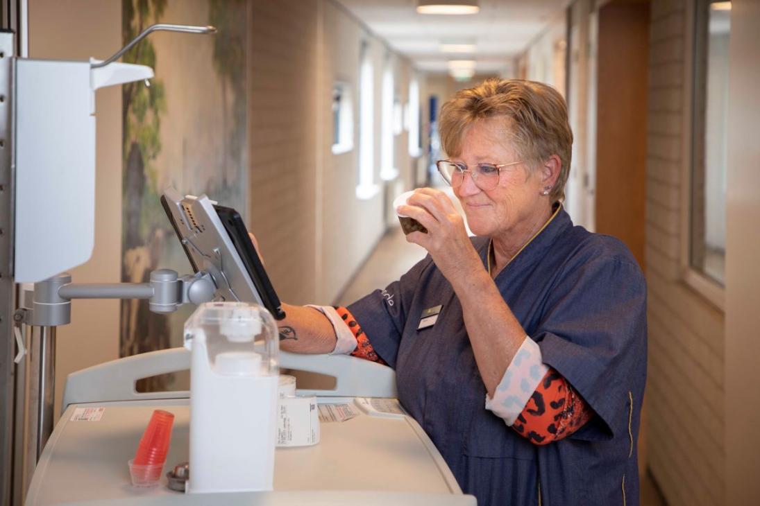 Rianne doet haar ronde in het wooncentrum; ze leest het medicijnenpotje